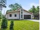 Beautiful modern home with a sleek dark garage door, striking windows, and fresh green lawn at 2689 Pearl St, Columbus, IN 47201