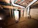 Basement view shows the water heater and utilities of the home at 3000 Pearl St, Anderson, IN 46016