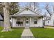 Charming home featuring a welcoming front porch and a well-maintained lawn at 3000 Pearl St, Anderson, IN 46016