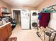 Functional laundry area features a washer, dryer and utility sink, offering convenience and storage at 3000 Pearl St, Anderson, IN 46016