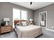 Bright bedroom features neutral gray walls, large window and closet with sliding doors at 326 N Summit St, Indianapolis, IN 46201