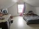 Attic bedroom featuring a window, bed, and some storage space at 3624 Columbus Ave, Anderson, IN 46013