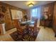 Elegant dining room with a glass table and a mix of wood and leather chairs, perfect for hosting at 3624 Columbus Ave, Anderson, IN 46013