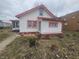 Exterior view of a two-story home with red accents and a small yard at 3624 Columbus Ave, Anderson, IN 46013