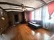 Cozy living room featuring hardwood floors, ceiling fan, and ample natural light at 3624 Columbus Ave, Anderson, IN 46013