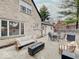Backyard stone patio featuring outdoor seating, fire pit, and view of home's exterior at 3659 Watson Rd, Indianapolis, IN 46205