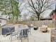 Backyard featuring a stone patio with seating and a grill, perfect for outdoor entertaining at 3659 Watson Rd, Indianapolis, IN 46205