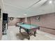 Basement rec room with a pool table, brick accent wall, and lounge seating at 3659 Watson Rd, Indianapolis, IN 46205