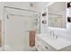 Bright bathroom featuring tiled shower with glass door and white vanity at 3659 Watson Rd, Indianapolis, IN 46205