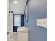 Bathroom features a single sink, shower, window, and neutral-colored tiling at 3659 Watson Rd, Indianapolis, IN 46205