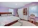 A brightly colored bedroom features a bed, vanity, closet and natural light at 3659 Watson Rd, Indianapolis, IN 46205