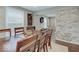 Inviting dining room with hardwood floors and stone accent wall, perfect for Gathering meals at 3659 Watson Rd, Indianapolis, IN 46205