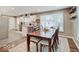 Dining room with a large wooden table, seating for eight and natural light at 3659 Watson Rd, Indianapolis, IN 46205