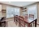 Dining room with large wooden table, lots of natural light and bar stool seating at 3659 Watson Rd, Indianapolis, IN 46205