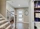 Foyer with tiled floors, wooden stairs and white door with windows at 3659 Watson Rd, Indianapolis, IN 46205