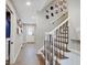 Entryway with stairs, tiled floor and white walls decorated with photos at 3659 Watson Rd, Indianapolis, IN 46205