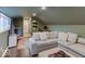 Living area with green walls, wood floors, and a large gray sectional couch at 3659 Watson Rd, Indianapolis, IN 46205