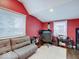 Office space with red walls, two windows, a gray couch and desk setup at 3659 Watson Rd, Indianapolis, IN 46205