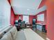 Office space with red walls, a gray couch and desk setup at 3659 Watson Rd, Indianapolis, IN 46205