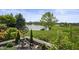 Green backyard with view of a lake and fountain, with decorative landscaping at 4857 W Congress Cv, New Palestine, IN 46163