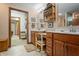 Bathroom featuring double sinks, vanity with seating, and an open doorway at 4857 W Congress Cv, New Palestine, IN 46163