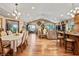 Spacious dining room connected to the living area, featuring hardwood floors and elegant lighting at 4857 W Congress Cv, New Palestine, IN 46163