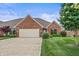 Charming brick home with a well-maintained lawn and a two-car garage on a sunny day at 4857 W Congress Cv, New Palestine, IN 46163
