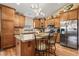 Modern kitchen with stainless steel appliances, wood cabinets, and a center island with seating at 4857 W Congress Cv, New Palestine, IN 46163