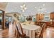 Open-concept living area with hardwood floors, high ceilings, and a seamless flow between rooms at 4857 W Congress Cv, New Palestine, IN 46163