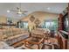 Bright living room with comfortable seating, a ceiling fan, and views of the outdoors at 4857 W Congress Cv, New Palestine, IN 46163