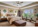 Spacious main bedroom with a ceiling fan, sitting area, and plenty of natural light at 4857 W Congress Cv, New Palestine, IN 46163