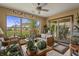 Bright sunroom featuring a ceiling fan, large windows, and a sliding door at 4857 W Congress Cv, New Palestine, IN 46163