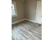 Cozy bedroom with gray walls and flooring, creating a peaceful atmosphere with a view at 5206 E St Clair St, Indianapolis, IN 46219
