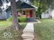 Charming home with a blue exterior, wood siding, and well-manicured lawn at 5206 E St Clair St, Indianapolis, IN 46219