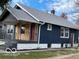 Craftsman home with blue siding, wood accents, and newly painted porch at 5206 E St Clair St, Indianapolis, IN 46219