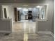 Open-concept living area with kitchen view, modern appliances, and stylish floors at 5206 E St Clair St, Indianapolis, IN 46219