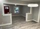 Bright living room with light-colored wood floors and modern lighting fixture at 5206 E St Clair St, Indianapolis, IN 46219