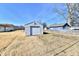 View of backyard and detached garage with garage door at 613 S Mickley Ave, Indianapolis, IN 46241