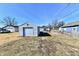 View of backyard and detached garage with garage door at 613 S Mickley Ave, Indianapolis, IN 46241