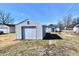 View of backyard and detached garage with garage door at 613 S Mickley Ave, Indianapolis, IN 46241