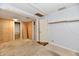 Unfinished basement area with wood paneling, neutral walls and access to other rooms at 613 S Mickley Ave, Indianapolis, IN 46241