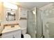 Bathroom features a glass-doored shower, vanity, and toilet; it awaits personalized renovation at 613 S Mickley Ave, Indianapolis, IN 46241