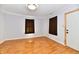 Bedroom featuring wood-look floors, neutral paint and curtains at 613 S Mickley Ave, Indianapolis, IN 46241