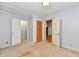 A simple bedroom with three doors, awaiting your personal touch for renovation at 613 S Mickley Ave, Indianapolis, IN 46241