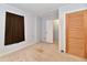 Functional bedroom with light walls, carpeted floors, and closet access at 613 S Mickley Ave, Indianapolis, IN 46241