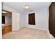 A simple bedroom with a window and a door, awaiting your personal touch for renovation at 613 S Mickley Ave, Indianapolis, IN 46241