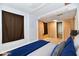 Bedroom with wooden paneling and a large window featuring virtual staging at 613 S Mickley Ave, Indianapolis, IN 46241