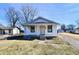 Charming single-story home with a covered front porch, white siding, and well-maintained landscaping at 613 S Mickley Ave, Indianapolis, IN 46241