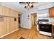 Open-concept kitchen with wood-paneled wall and laminate flooring at 613 S Mickley Ave, Indianapolis, IN 46241