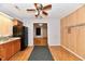 Functional kitchen featuring laminate flooring, wood cabinets, and modern black appliances at 613 S Mickley Ave, Indianapolis, IN 46241